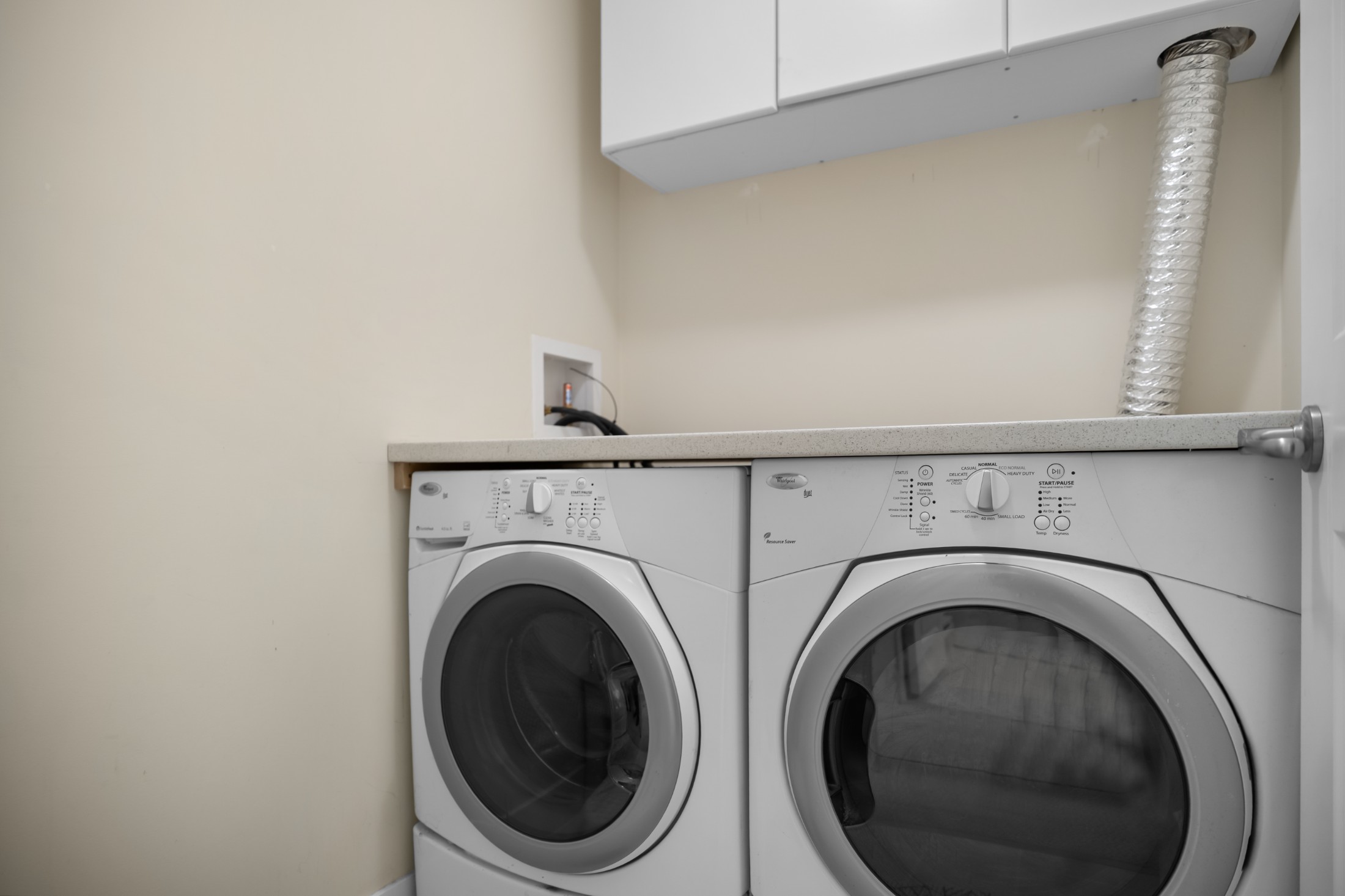         Laundry room with cabinet storage
